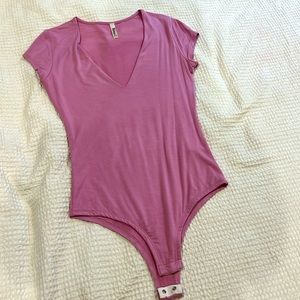 Baby pink short sleeve body suit, size small.